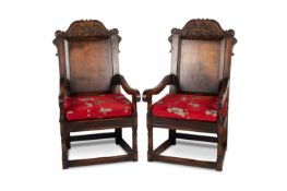 A LARGE PAIR OF PERIOD STYLE OAK PANEL-BACK ARMCHAIRS