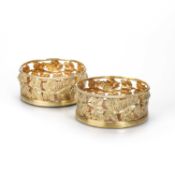 A PAIR OF GEORGE III SILVER-GILT WINE COASTERS