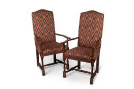 A PAIR OF GEORGIAN STYLE OAK AND UPHOLSTERED OPEN ARMCHAIRS