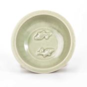 A CHINESE MOULDED CELADON TWIN-FISH BOWL