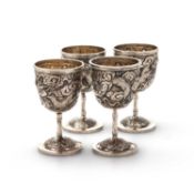 A SET OF FOUR CHINESE SILVER EGG CUPS
