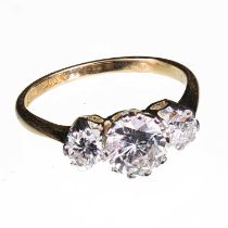 AN 18 CARAT YELLOW GOLD AND DIAMOND THREE STONE RING