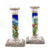 A PAIR OF EDWARDIAN SILVER AND ENAMEL CANDLESTICKS
