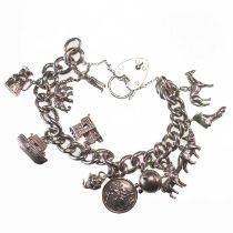 A SILVER CURB LINK CHARM BRACELET