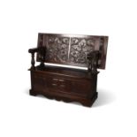 A CARVED OAK MONKS BENCH, LATE 19TH/ EARLY 20TH CENTURY