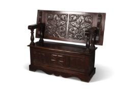 A CARVED OAK MONKS BENCH, LATE 19TH/ EARLY 20TH CENTURY