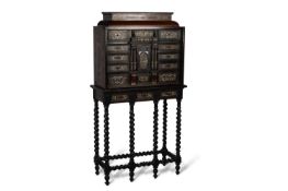 A LATE 17TH CENTURY EBONISED AND IVORY-INLAID CABINET ON STAND