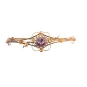 AN EDWARDIAN 9 CARAT YELLOW GOLD AMETHYST AND SEED PEARL BROOCH