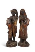 A LARGE PAIR OF COLD-PAINTED TERRACOTTA FIGURES OF ARAB WATER CARRIERS, PROBABLY GOLDSCHEIDER