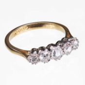 AN 18 CARAT YELLOW GOLD AND DIAMOND FIVE STONE RING