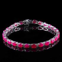 AN 18K WHITE GOLD RUBY AND DIAMOND LINE BRACELET