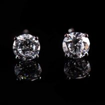 A PAIR OF 18K WHITE GOLD AND DIAMOND SINGLE STONE STUD EARRINGS