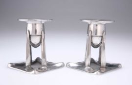 ARCHIBALD KNOX (1864-1933) FOR LIBERTY & CO, A PAIR OF TUDRIC PEWTER CANDLESTICKS