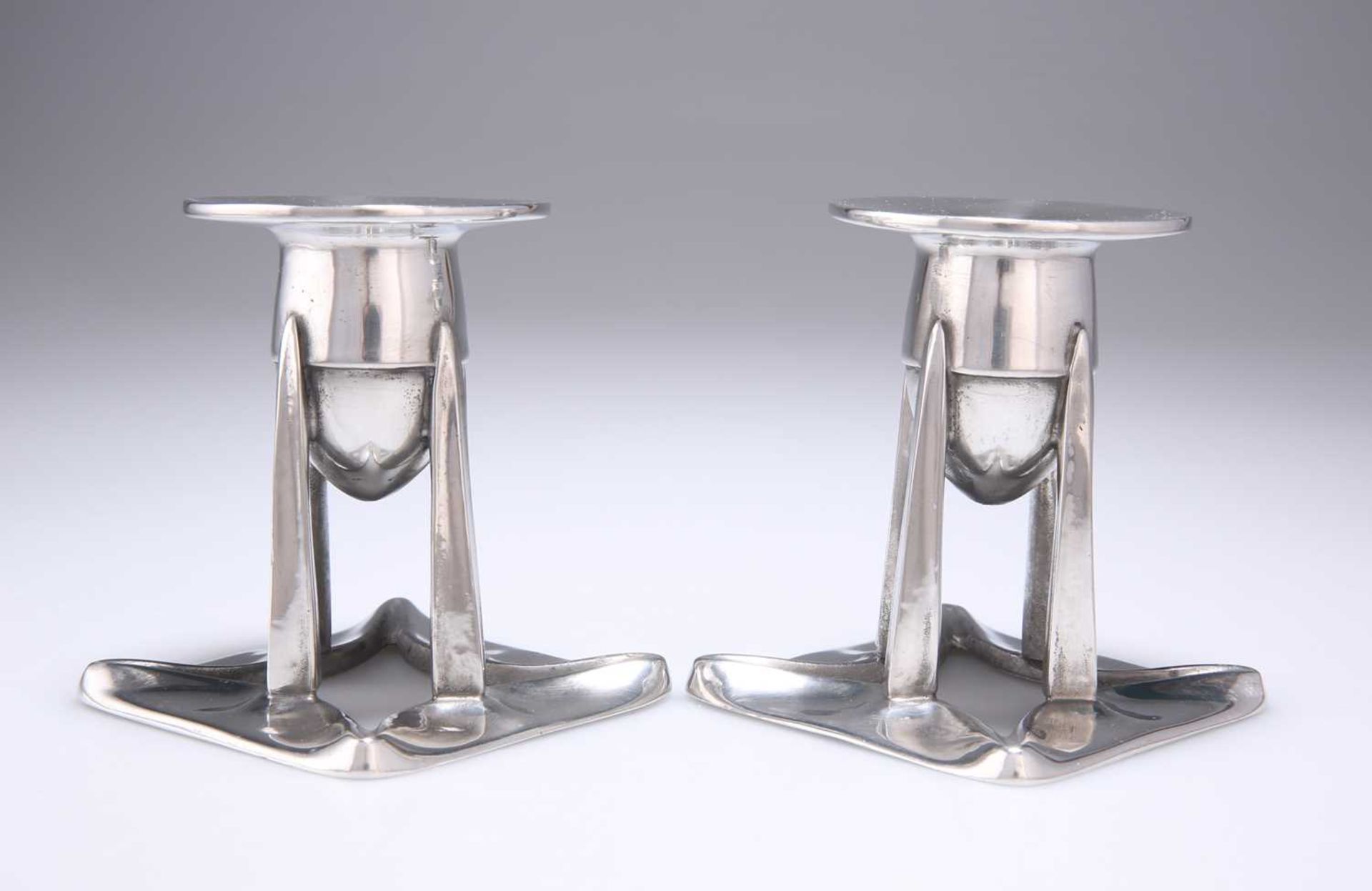 ARCHIBALD KNOX (1864-1933) FOR LIBERTY & CO, A PAIR OF TUDRIC PEWTER CANDLESTICKS