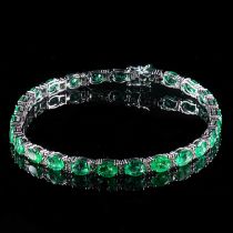 AN 18K WHITE GOLD, EMERALD AND DIAMOND LINE BRACELET