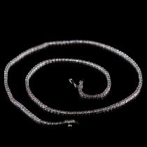 AN 18K WHITE GOLD AND DIAMOND LINE NECKLACE