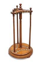 A LATE 19TH CENTURY OAK REVOLVING SNOOKER CUE STAND