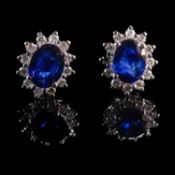 A PAIR OF 18K WHITE GOLD, SAPPHIRE AND DIAMOND OVAL CLUSTER EARRINGS