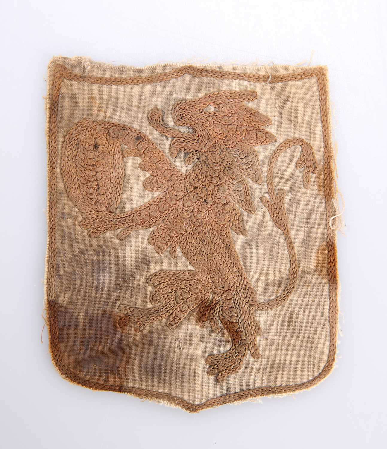 AN ANTIQUE EMBROIDERED HERALDIC BADGE PENDANT