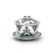 A CHINESE DOUCAI TEA BOWL, COVER AND STAND