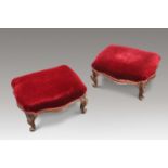 A PAIR OF VICTORIAN WALNUT AND UPHOLSTERED FOOTSTOOLS