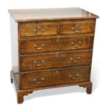 A GEORGE III OAK CHEST OF DRAWERS