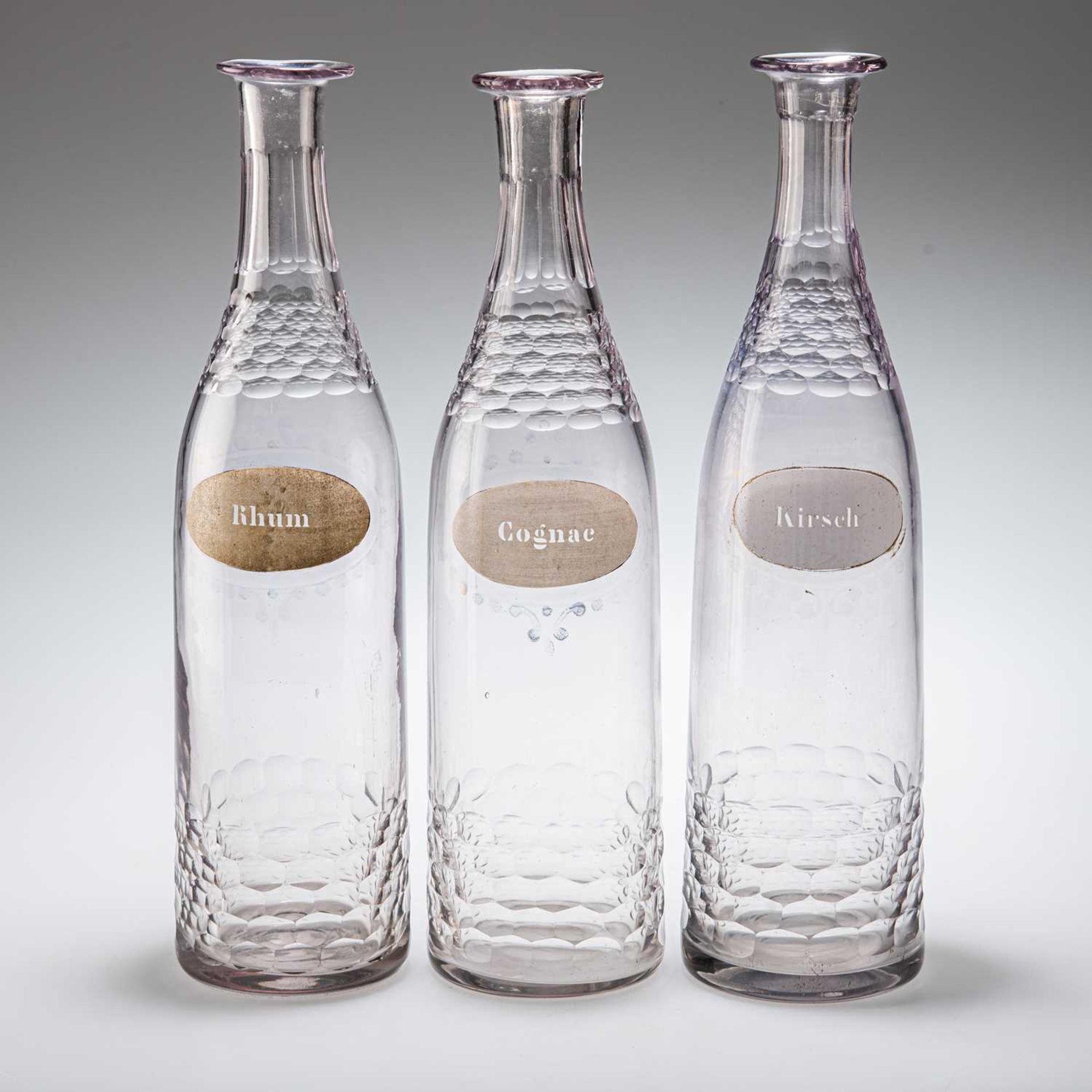 A SET OF THREE BACCARAT CUT-GLASS DECANTERS