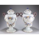A PAIR OF 19TH CENTURY POLYCHROME DUTCH DELFT PHARMACY JARS AND COVERS
