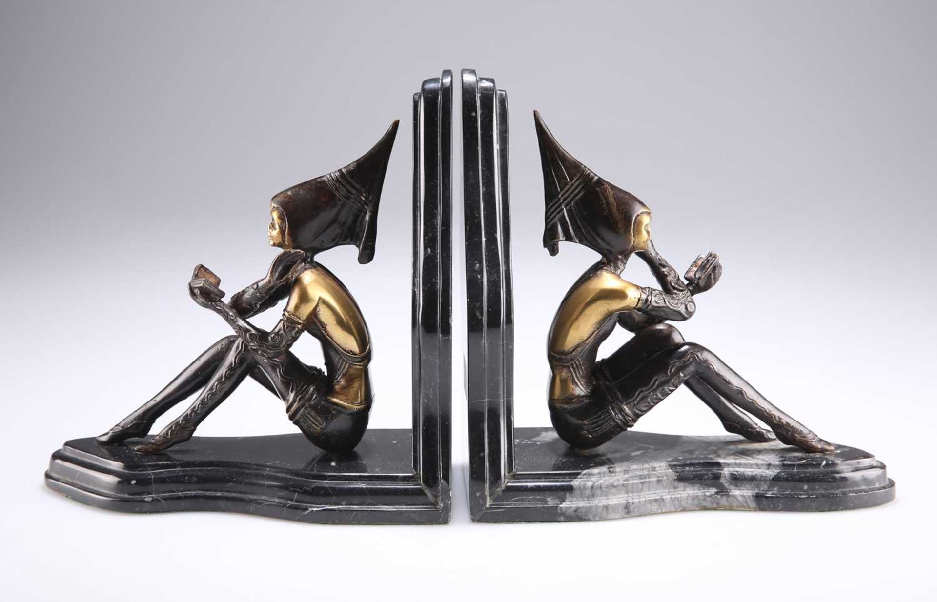 AFTER LORENZL, A PAIR OF ART DECO STYLE BRONZE AND MARBLE BOOKENDS