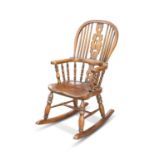 A PERIOD-STYLE ELM AND OAK CHILD'S ROCKING CHAIR