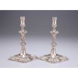 A PAIR OF GEORGE II CAST SILVER TAPERSTICKS