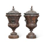 A LARGE PAIR OF CARVED WOOD URNS AND COVERS