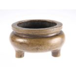 A SMALL CHINESE BRONZE CENSER OF CAULDRON FORM