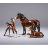 A BESWICK MODEL OF AN EXMOOR PONY AND TWO BESWICK MODELS OF FOALS