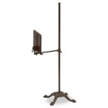 A VICTORIAN BRASS, CAST IRON AND MAHOGANY ADJUSTABLE MUSIC STAND