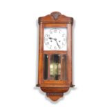 A 1930S OAK WALK CLOCK.