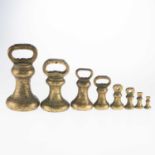 A GRADUATED SET OF EIGHT 19TH CENTURY BRASS BELL WEIGHTS