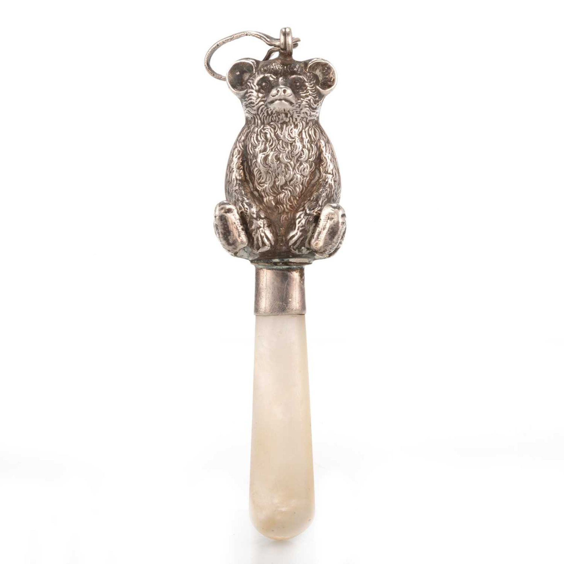 A GEORGE V SILVER MOUNTED MOTHER OF PEARL BABY TEETHER