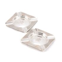 A PAIR OF ENGINE-TURNED SILVER ASHTRAYS