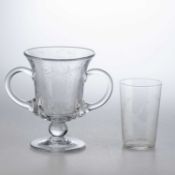 A TWO-HANDLED GLASS LOVING CUP TOGETHER WITH A GLASS BEAKER OF MASONIC INTEREST