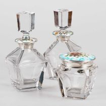 A SET OF THREE SPANISH SILVER, ENAMEL AND GLASS DRESSING TABLE JARS/ BOTTLES