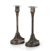 A PAIR OF SECESSIONIST SILVERED METAL CANDLESTICKS