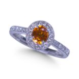 18CT WHITE GOLD, ORANGE SAPPHIRE AND DIAMOND CLUSTER RING.