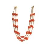 A THREE ROW 18CT YELLOW GOLD AND CORAL NECKLACE.