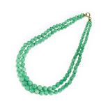 A TWO ROW APPLE GREEN JADE BEADS NECKLACE.