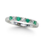 AN EMERALD AND DIAMOND SEVEN STONE RING, IN PLATINUM.