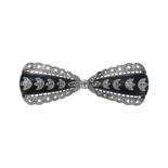 AN ANTIQUE EDWARDIAN BLACK WOOD AND DIAMOND BOW TIE BROOCH, IN YELLOW GOLD AND PLATINUM.