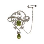 AN ANTIQUE EDWARDIAN PERIDOT AND DIAMOND BROOCH, IN PLATINUM AND YELLOW GOLD.
