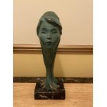 Bronze Sculpture of a Woman's Head on Marble Base.