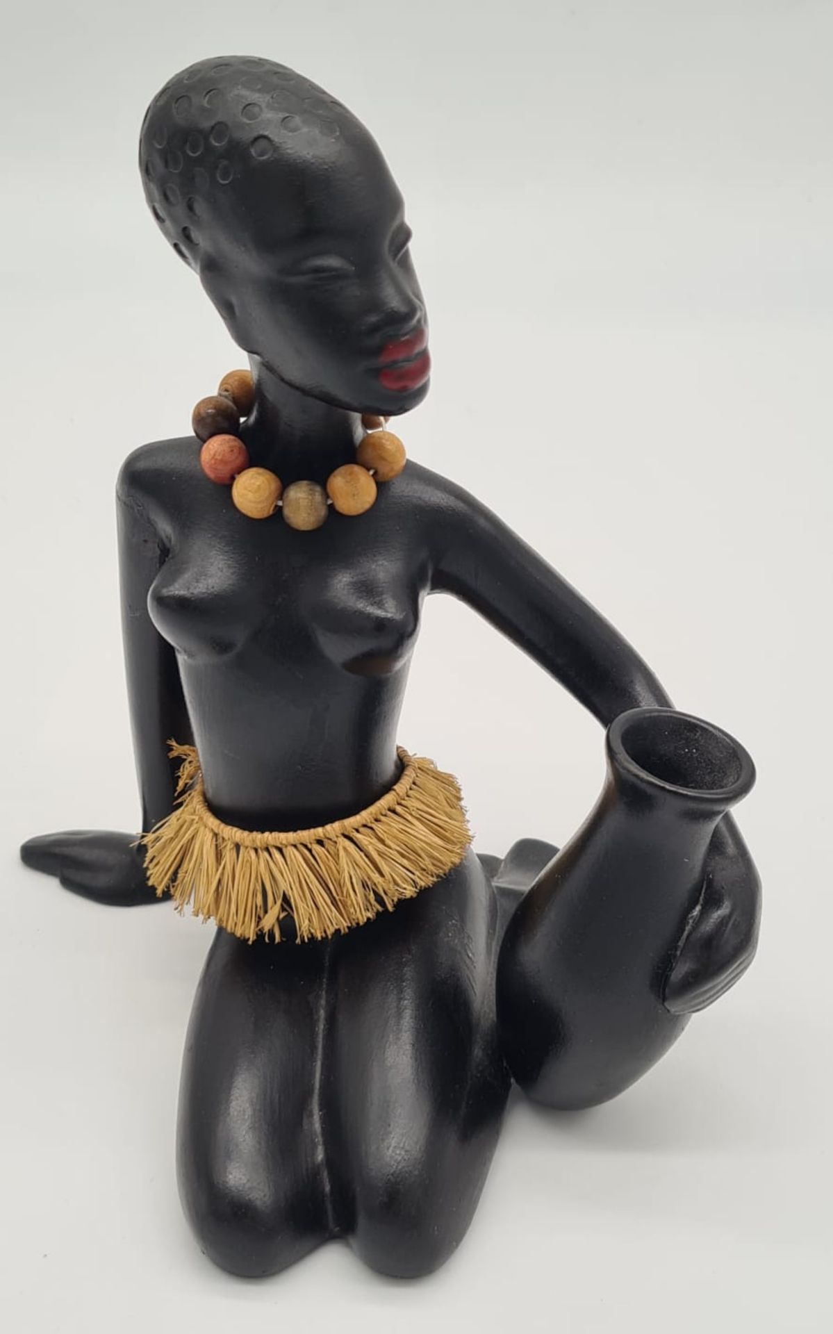 Sitzende Afrikanerin mit Wasserkrug ,Gmundner Keramik/Austria , schwarz glasiert, mit Baströckchen 
